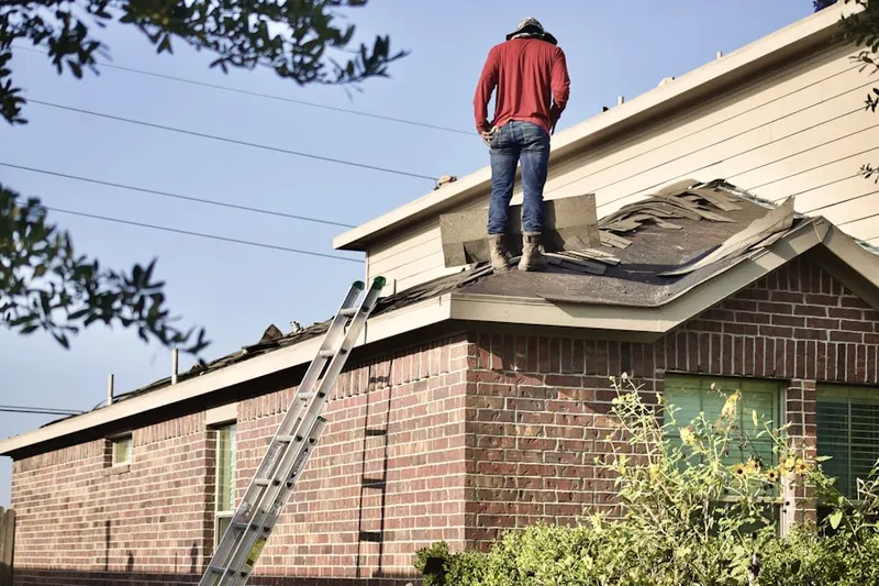 Professional roofer working on a residential roof in Day - Mar Village